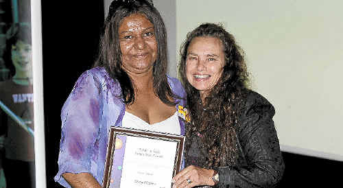 Induna School teacher Tanya Flanders receives her award from Michelle Hall, director of Aboriginal Education and Training. Induna School teacher Tanya Flanders receives her award from Michelle Hall, director of Aboriginal Education and Training.